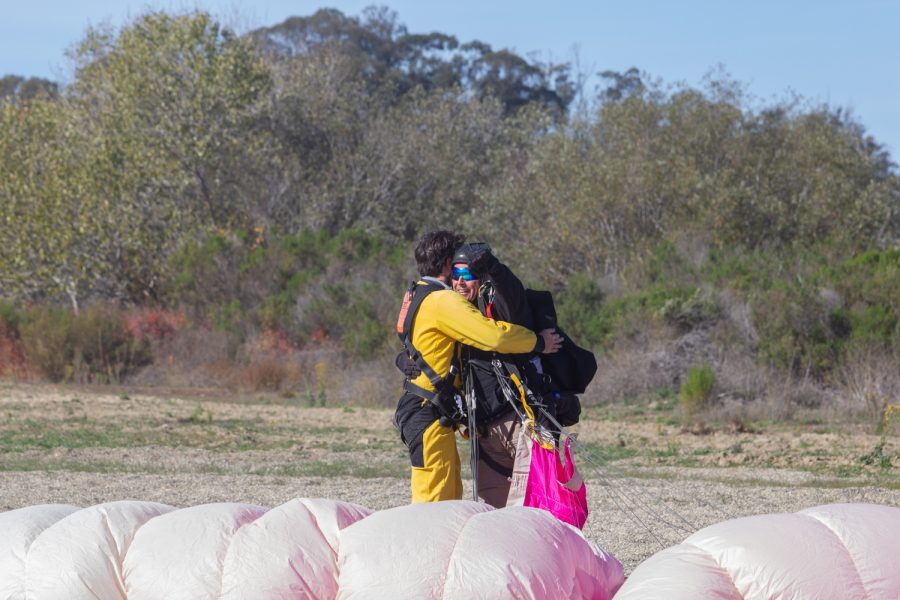 A skydiver hugs his instructor, Tom Pecharich (right), after landing safely at the dropzone on Nov. 20 at Skydive Santa Barbara in Lompoc, Calif. Skydivers are only in the air for five minutes from when they leave the plane to when they touch the ground.