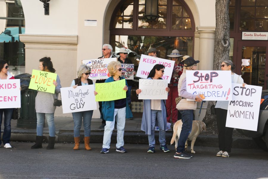Anti-Drag story time protesters gather on the corner of State and Figueroa streets on Feb. 11 in Santa Barbara, Calif. Some of the signs read keep kids innocent, Miss Angel is a guy, and stop targeting children.