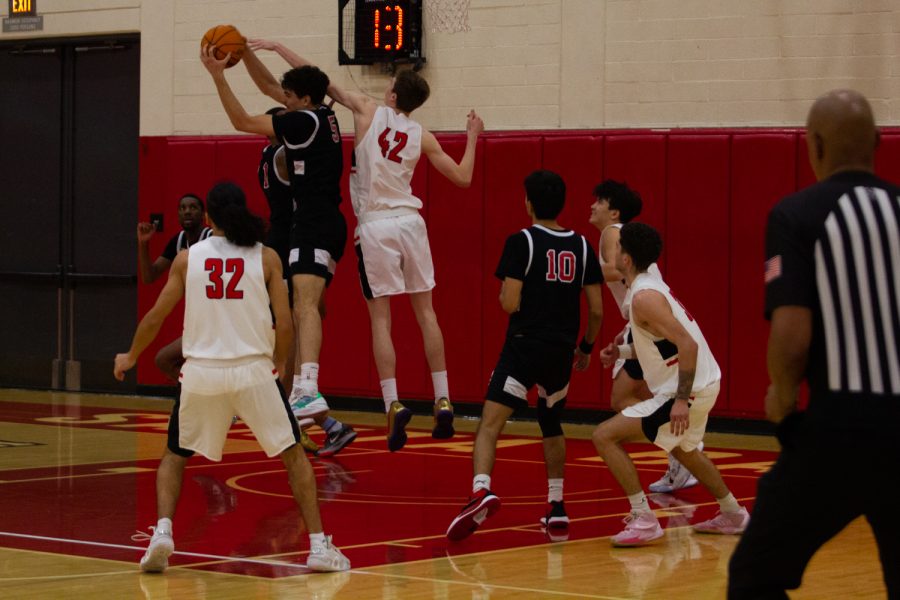 Number 42, Aidan Mandel, attempts to steal the ball from an opponent on Feb. 5 at City college, Santa Barbara, Calif. Mandel is the tallest player on the basketball team, at 63.