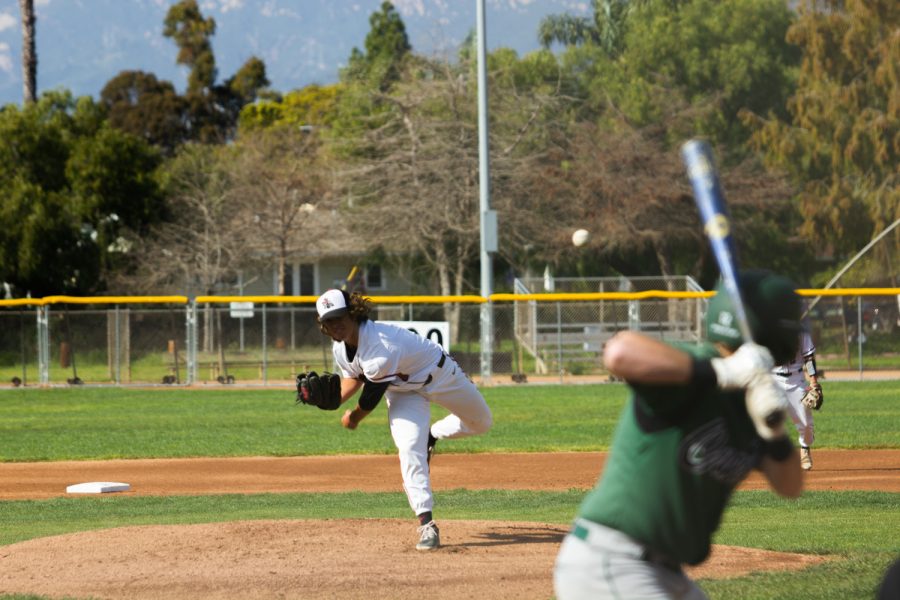Starting left hand pitcher Jake Villar (No. 7) gives it his all even with a losing scoreboard. Villar throws the ball as the Cougar player awaits the pitch. The Vaqueros lost 0-3 against the Cuesta College Cougars at their home game at 2 p.m. On Feb. 21 at Pershing Park in Santa Barbara Calif.
