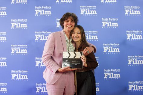 Albert DiCesare, actor in the winning film ‘Until Morning’ embracing co-actress Sydney Davidson. DiCesare is wearing his pink suit that he wore in the film while walking the red carpet after the show on Saturday, Feb. 18, 2023 in Santa Barbara Calif.