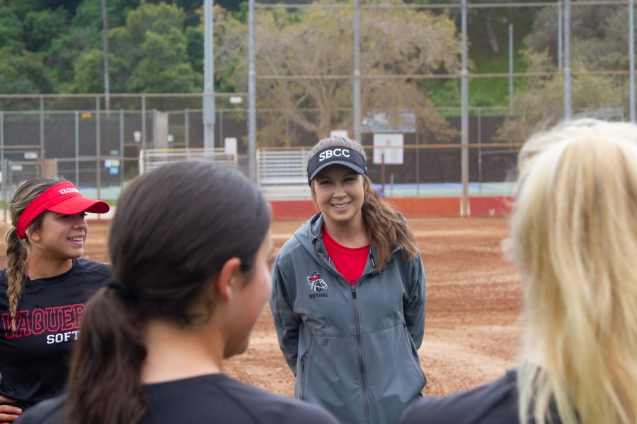 City Colleges head softball coach, Jasmyne Perry smiles as she holds a team meeting about their upcoming game against Saddleback College before practice on March 16 at Pershing Park in Santa Barbara, Calif.