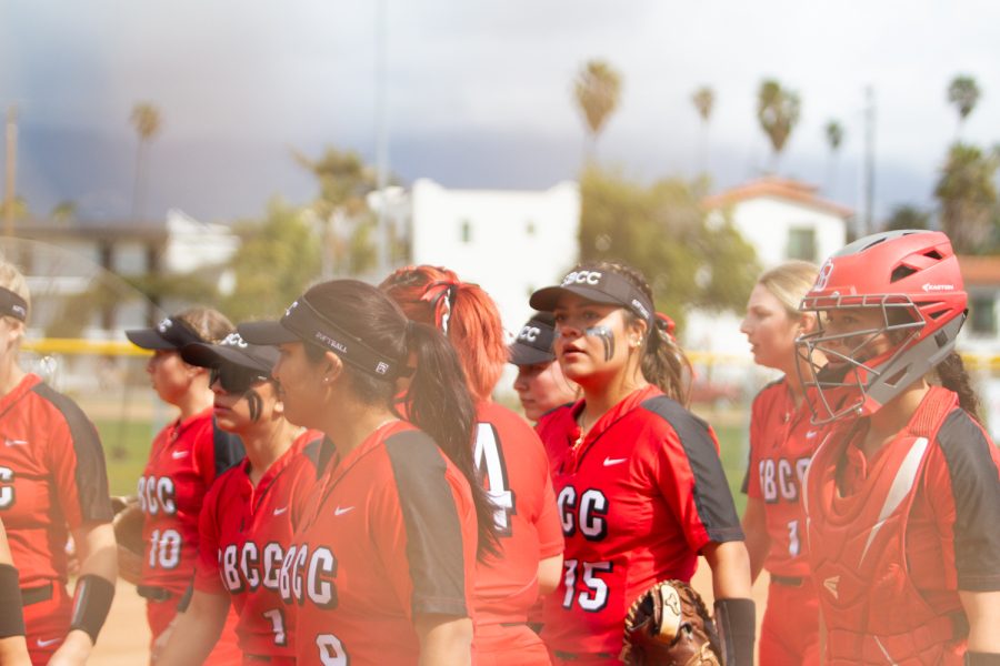 The Vaqueros end their team huddle, moving to the dugout to get ready to bat at the bottom of the inning of the first game of the doubleheader. Melanie Barth, number 15, is staring out into the crowd that came for the game on Saturday, March 4 in Santa Barbara, Calif.