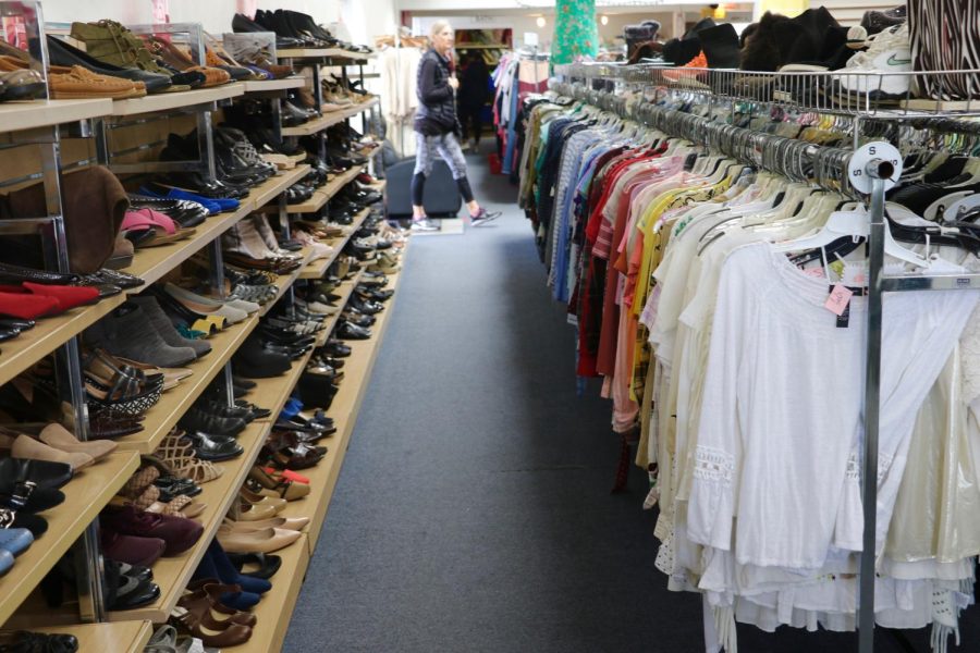 A shopper strolls by the clothing racks on March 13 at Alpha Thrift in Santa Barbara, Calif. The two-story building on Milpas Street also has a store on Hollister Ave in Goleta.