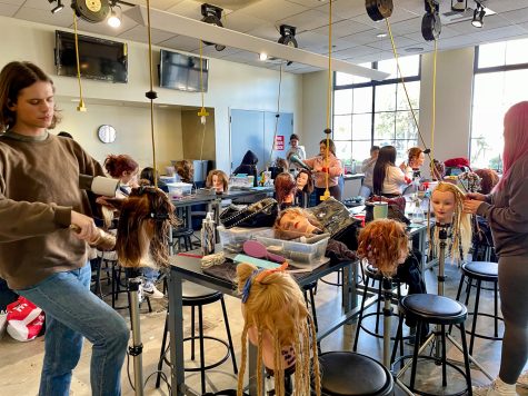 In the working station, the cosmetology students work on mannequin heads. Each student is styling each mannequins hair as a way of practice on Monday, Feb. 27.