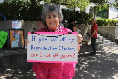 Marian Shapiro, 80, radiates during the reproductive rights protest in front of the Santa Barbara Museum of Art on April 15th in Santa Barbara, Calif. Shapiro's sign reads, "If you cut off my Reproductive Choice, can I cut off yours?"