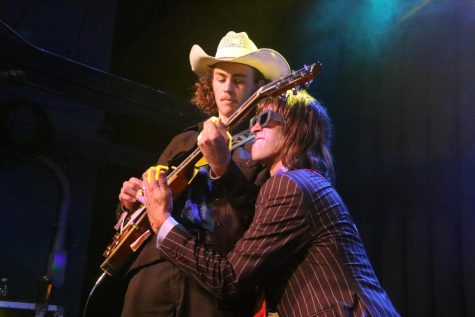 Glenn Annie bassist Justin Huntsman gives guitarist Luke Holroyd a hand with his encore solo after winning the Shabang Battle of the Bands on April 15 in Santa Barbara, Calif.