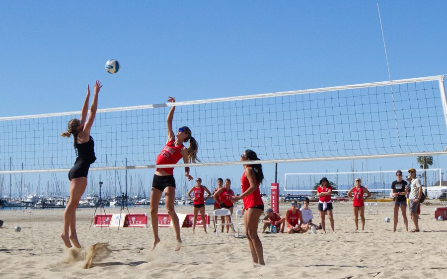 Karoline Ruiz (No. 10) jumps up to smash a ball. With a leading score of 20-13, Ruiz and teammate Jacelin McKie (No. 5) played with their team watching on Friday, April 21 at West Beach in Santa Barbara Calif.
