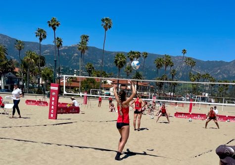 Corinne Tommeraason (No.1) is serving the ball on April 21 on West Beach in Santa Barbara, Calif. As the ball is being served, Bakersfield is in position to receive.