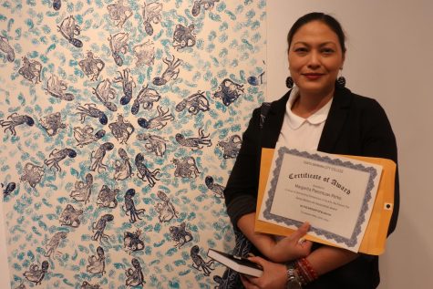 Margarita Pamintuan-Perko poses next to her piece titled "Octopus Multiple" that aided her with receiving a $1,000 scholarship for outstanding performance with the City College Arts Department on Thursday, April 20 in Santa Barbara, Calif. This is Pamintuan-Perko's first gallery as an art student at City College.