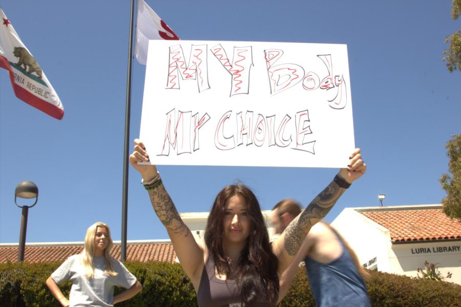 Gianna Cooper holds a sign reading My body my choice out front of the Luria Library on SBCC Campus on Wednesday, March 19 in Santa Barbara, Calif. counter-protesting an anti-abortion presentation. Cooper explained that she was walking back from class and saw the presentation, quickly turned around to grab posters and began protesting.