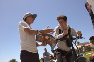 Maison Deschamps (left) explains his position on abortion to a passing student at the Great Meadow on SBCC's campus on Wednesday, March 19 in Santa Barbara, Calif. The organizations presenting their views handed out magazines featuring graphic content including images from the Holocaust.