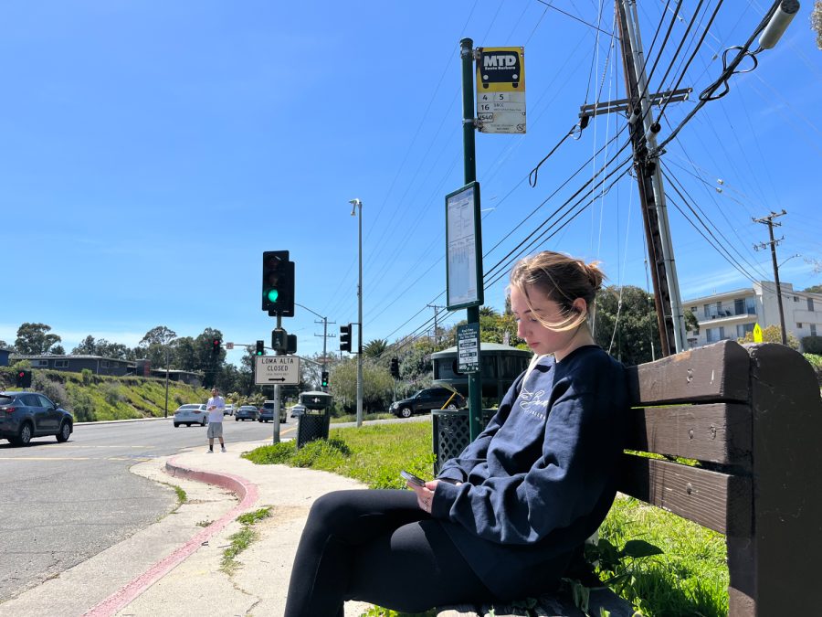19-year-old Kiera Oakeson sitting at the bus stop across from City College on Wednesday. April 5. Oakeson is a student at City College who takes the bus nearly every day, she says she has spent an estimate of $50 on Ubers she’s had to call because the bus never showed.