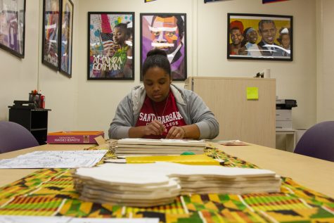 City College student Zoe Fleming participates in the activities offered at the Black History 365 event at the Umoja program. She sits at the table embellished with markers, wooden maps of Africa and puzzle pieces. Fleming begins her work on the puzzle on Wednesday, Feb. 15 at City College.