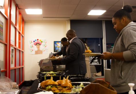 City College student Zoe Fleming and members of the faculty gather during the Black History 365 event and serve up their plates with complimentary sliders, salads and more. The whole Center of Equity and Social Justice (CESJ) room was full of chatter and laughter on Wednesday, Feb. 15 at City College.