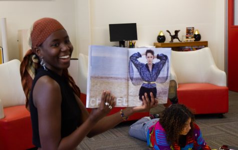 Diarra Pouye holds up a Chanel magazine to her friends in a circle of vision board scrapbooking on Tuesday, Feb. 28 at City College.