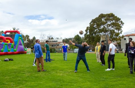 Students gather to pass a soccer ball back and forth to each other on Thursday, May 4 at the West Campus Lawn in Santa Barbara, Calif. The festival offered a range of activities, such as jolly jumping and lawn games.