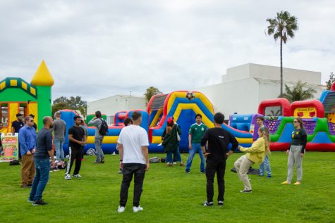 Students gather to pass a soccer ball back and forth to each other on Thursday, May 4 at the West Campus Lawn in Santa Barbara, Calif. The festival offered a range of activities, such as jolly jumping and lawn games.