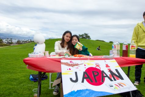 From left, representatives of Japan, Yuki Sando, and Katf Kikutani display their Japanese snacks for students and staff on Thursday, May 4 in Santa Barbara, Calif. Free food and drinks native to the booth’s country were offered to participants at most booths.