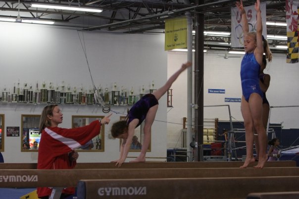 Delaney Newhouse completing a balance beam routine as a child in Gaithersburg, Md. "Only perfect practice makes perfect," was a phrase constantly repeated in training.