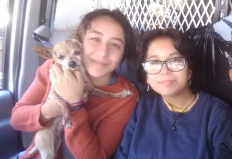 The Torres sisters, Julia and Gabriela smile together with their dog, Candy, on the road on a sunny day on Oct. 26.