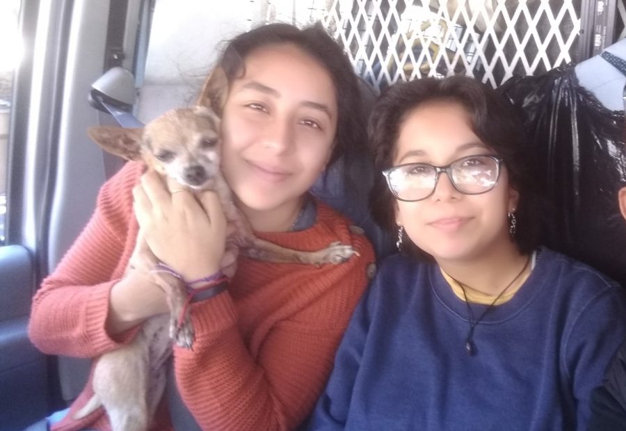 The+Torres+sisters%2C+Julia+and+Gabriela+smile+together+with+their+dog%2C+Candy%2C+on+the+road+on+a+sunny+day+on+Oct.+26.