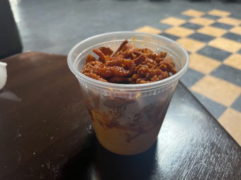 The Hot Cracklin' Mac in a container on Tuesday, May 9 at Soul Bites located in Santa Barbara, Calif. The mac and cheese sits at the bottom with spicy crispy chicken skin on top.
