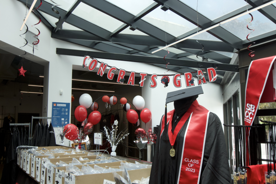 Graduation regalia for the class of 2023 is on display at the City College campus store in Santa Barbara, Calif. Students are picking up suitable cap and gown sizes as graduation approaches.