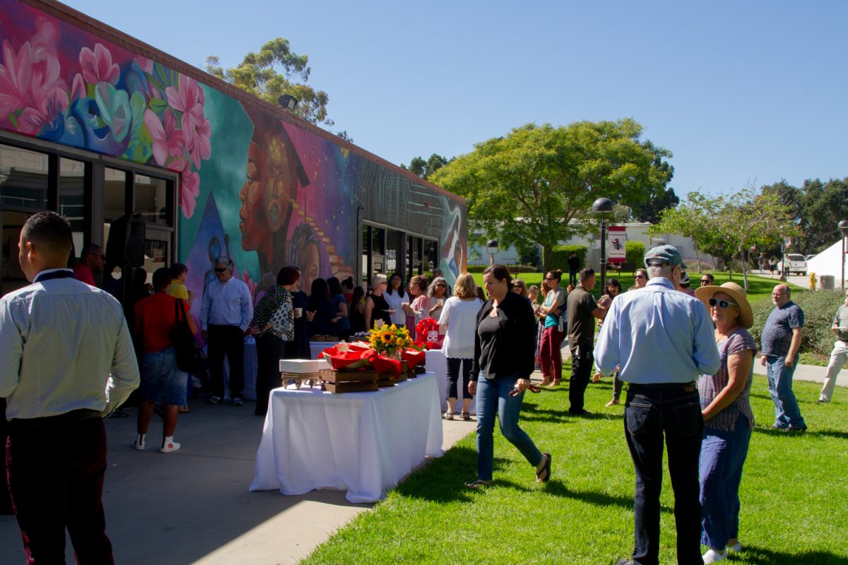 Faculty and students gather on Aug. 30 at Kindred Murillo’s retirement event at the Campus Center Umoja Mural at City College in Santa Barbara, Calif. Food, drinks, and colorful flowers are on display for all to see and enjoy.