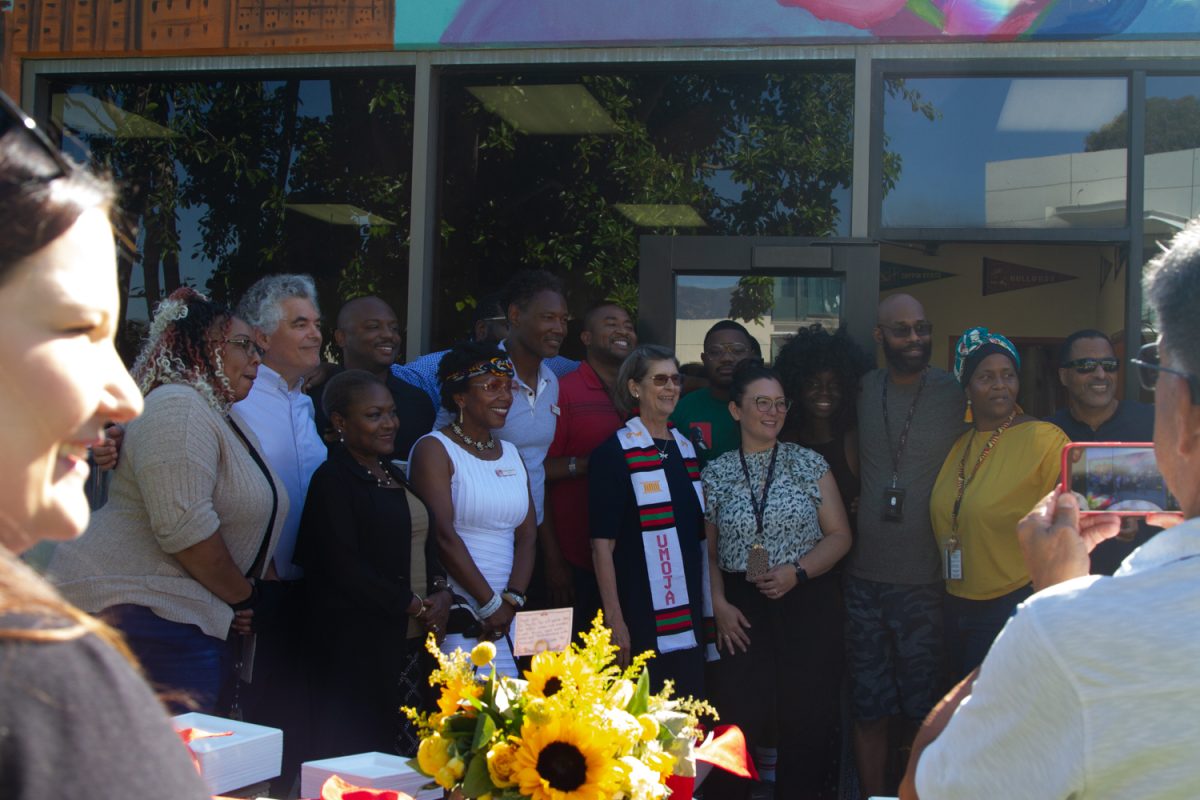 Kindred Murillo gleams during a photo with the staff of the Umoja program at the end of her retirement event on Aug. 30 at the Campus Center Umoja Mural at City College in Santa Barbara, Calif. Murillo served as interim superintendent-president for two years. (<a href="https://www.thechannels.org/staff_profile/sofia-stavins/">Sofia Stavins</a>)