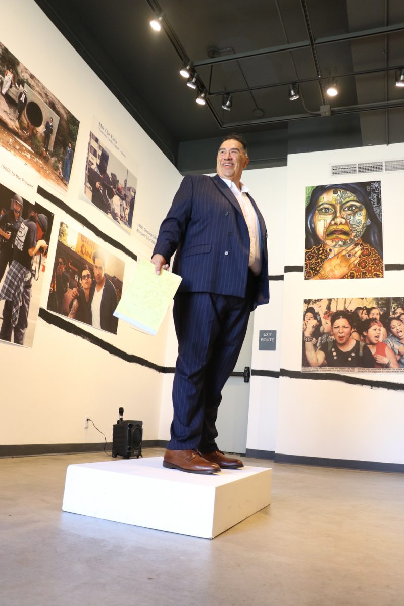 Curator Thomas Carrasco beams from ear to ear during his speech for his exhibition Xicana/o/x Time and Space, celebrating Chicanx culture on Wednesday, Sept. 6 at Santa Barbara City College. Carrasco is also an American Ethnic Studies professor at City College.