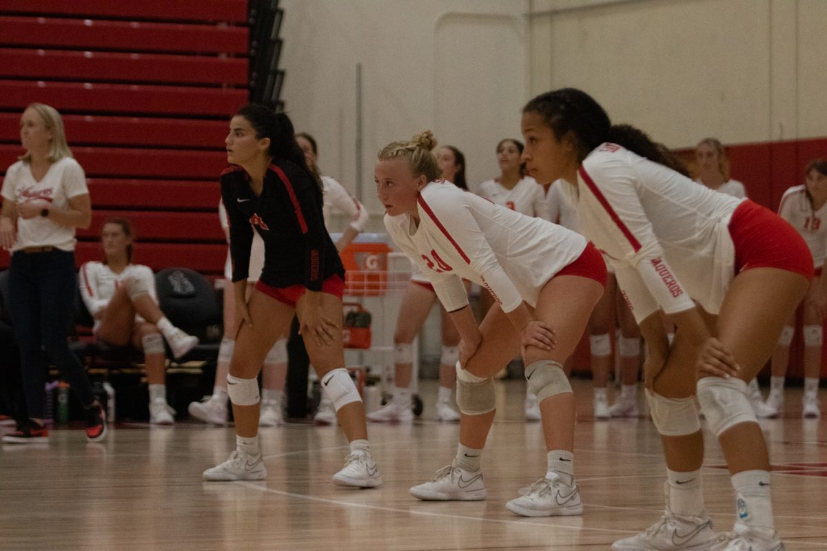 From left, libero Gabby Russell, outside hitter Kira Little, and ___ get into position to receive a ball from Moorpark College during their Friday night game on Sept. 29 in Santa Barbara, Calif. As the libero, Russel specializes as a defensive player, and commonly gets first touch during a play.