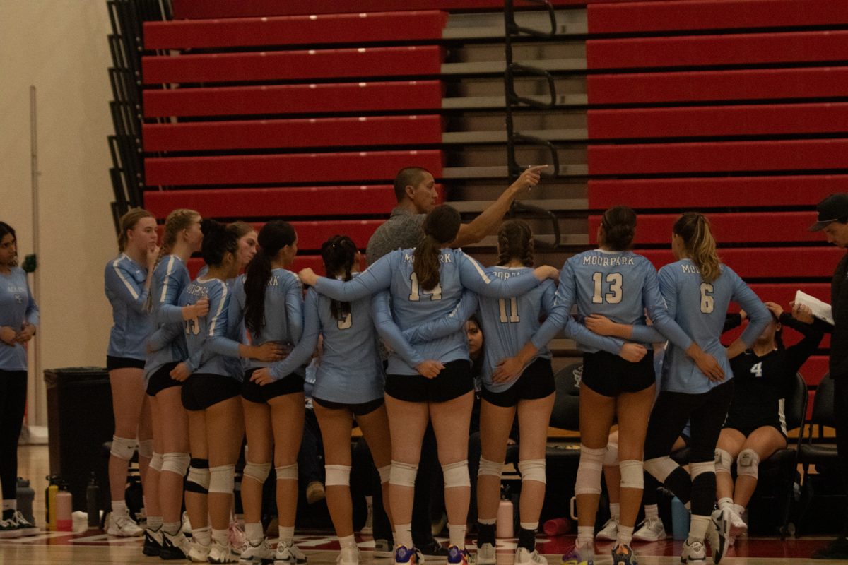 The Moorpark College women's volleyball team regroups during a timeout during their match against City College on Sept. 29 in Santa Barabra, Calif. Head Coach Adam Black signals where the team needs to be looking out on the court. 
