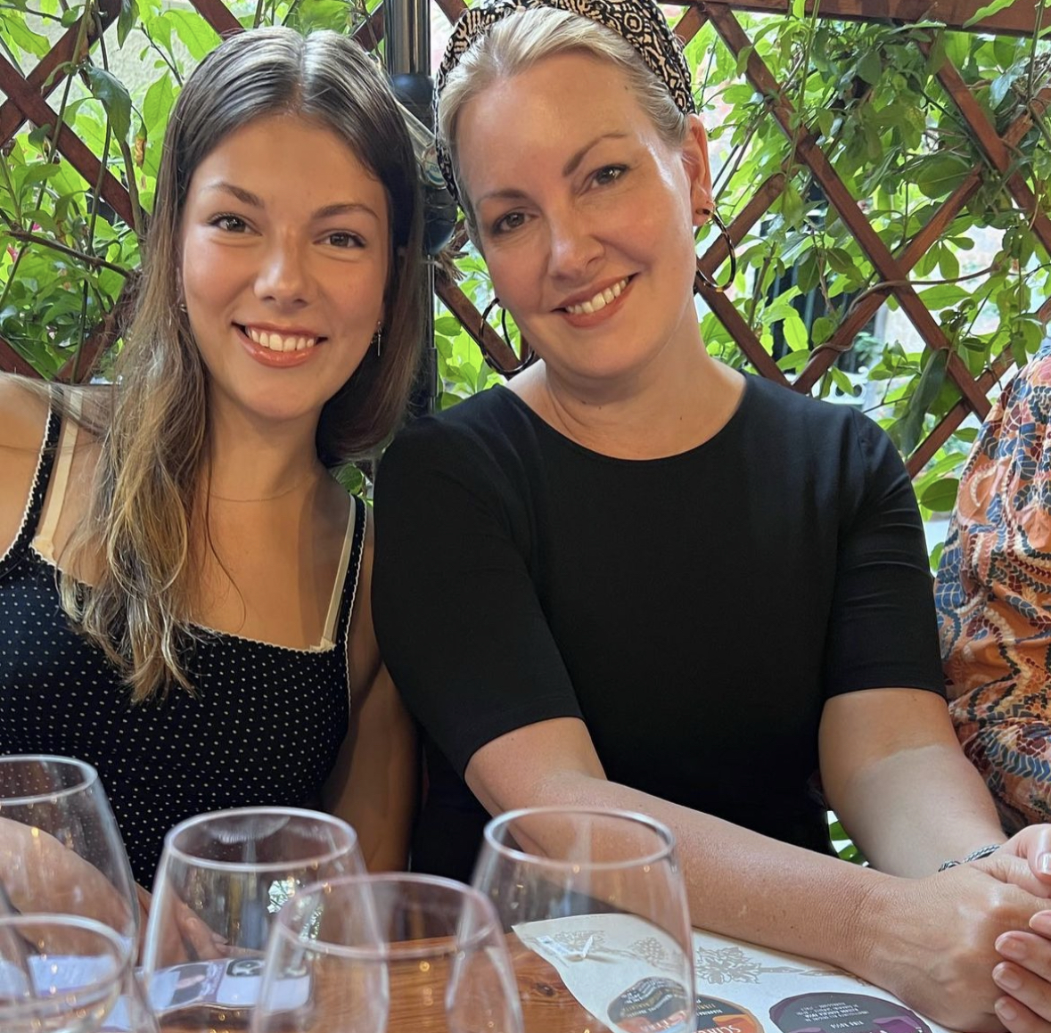 From left, Ruby Cobourn smiles at the dinner table with her mother on June 22 in Monterosso, Italy. They are a week into their European excursion together. 