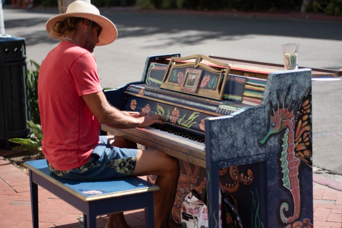 Justin William **QC** plays a piano painted by artists Stephanie Ingoldsby and Rebecca Zendejas on Oct. 12 on the corner of Canon Perdido and State streets in Santa Barbara, Calif. "I'm self taught... I've been playing for 37 years," William says.
