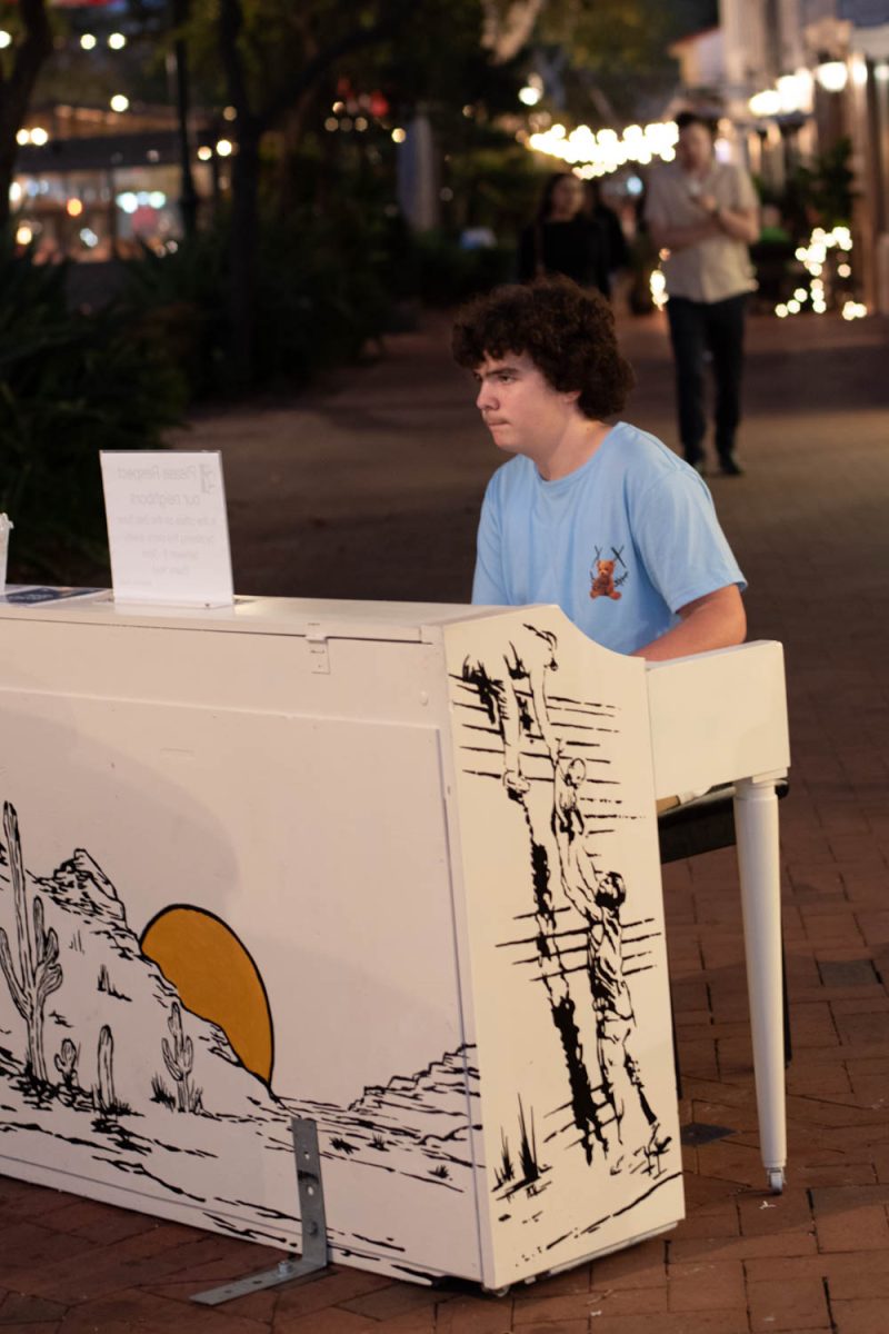 Andrew Brady plays the Pink Panther Theme song for passersby on Oct. 10 on the corner of Victoria and State streets in Santa Barbara, Calif. This piano was painted by Hello Coyote.