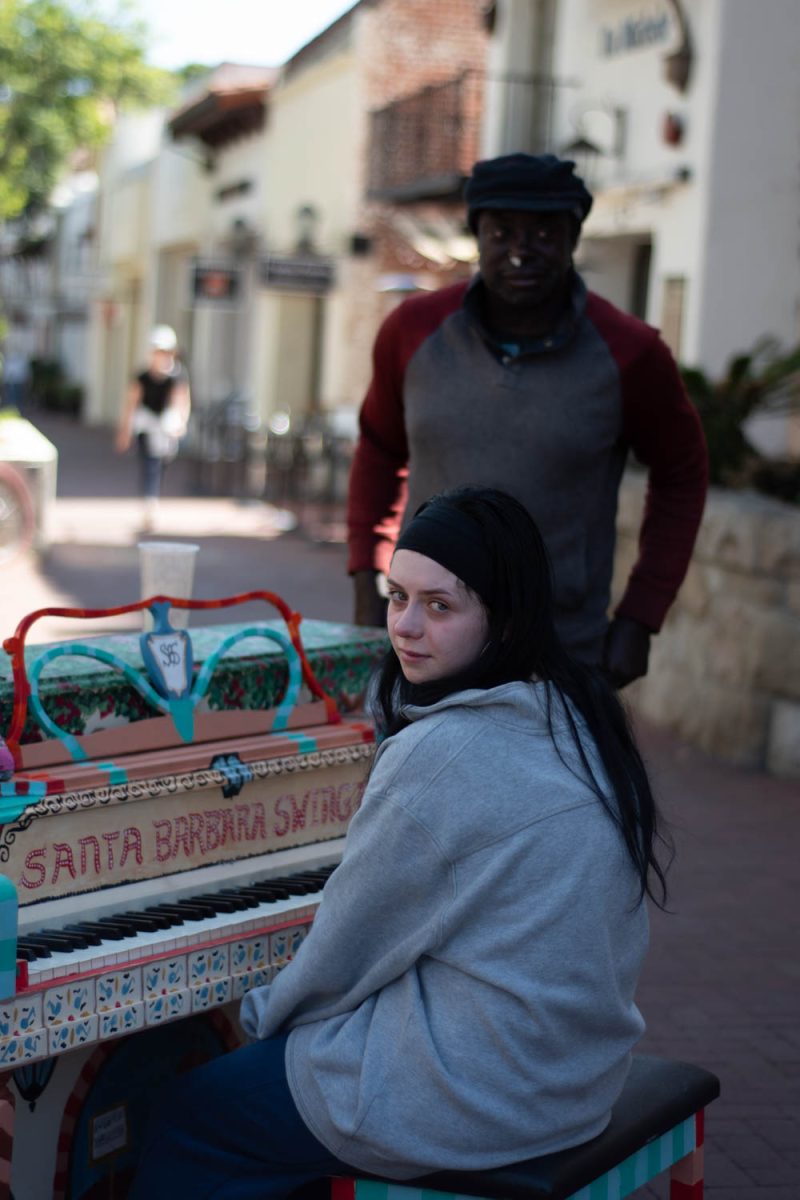 Hannah Mangold (front) smiles while chatting with Jerinimo **CQ** Chris (back) on Oct. 12 on the corner of Figueroa and State Streets in Santa Barbara, Calif. "I play magic,” Chris says. “I can't have anyone telling me what to do.”