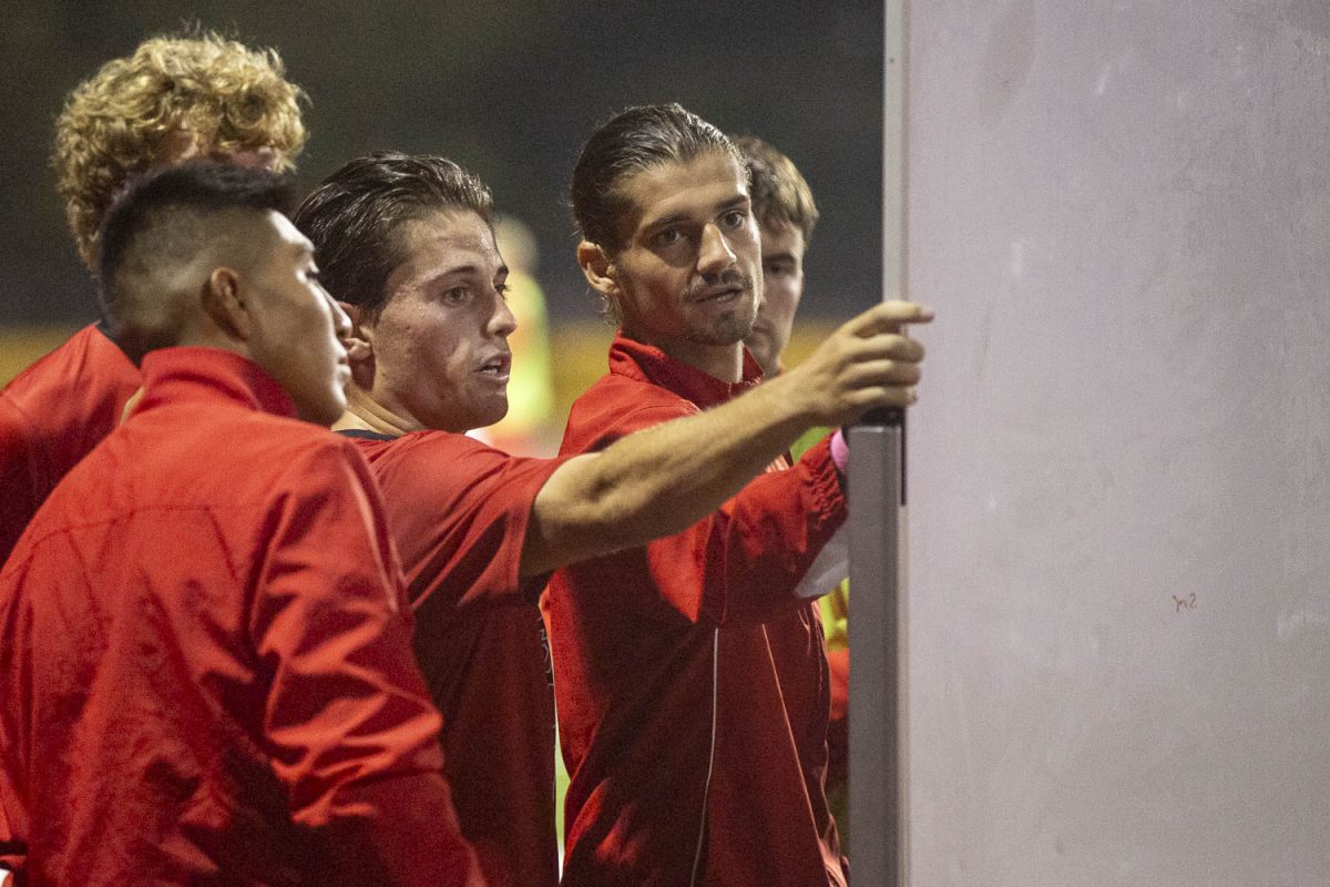 (From left) Junior Leon, Charles Jay Retzer, and Liam Wilder talk about strategies during the halftime break on Oct 16. The Vaqueros took on the Condors at La Playa Stadium in Santa Barbara, Calif.