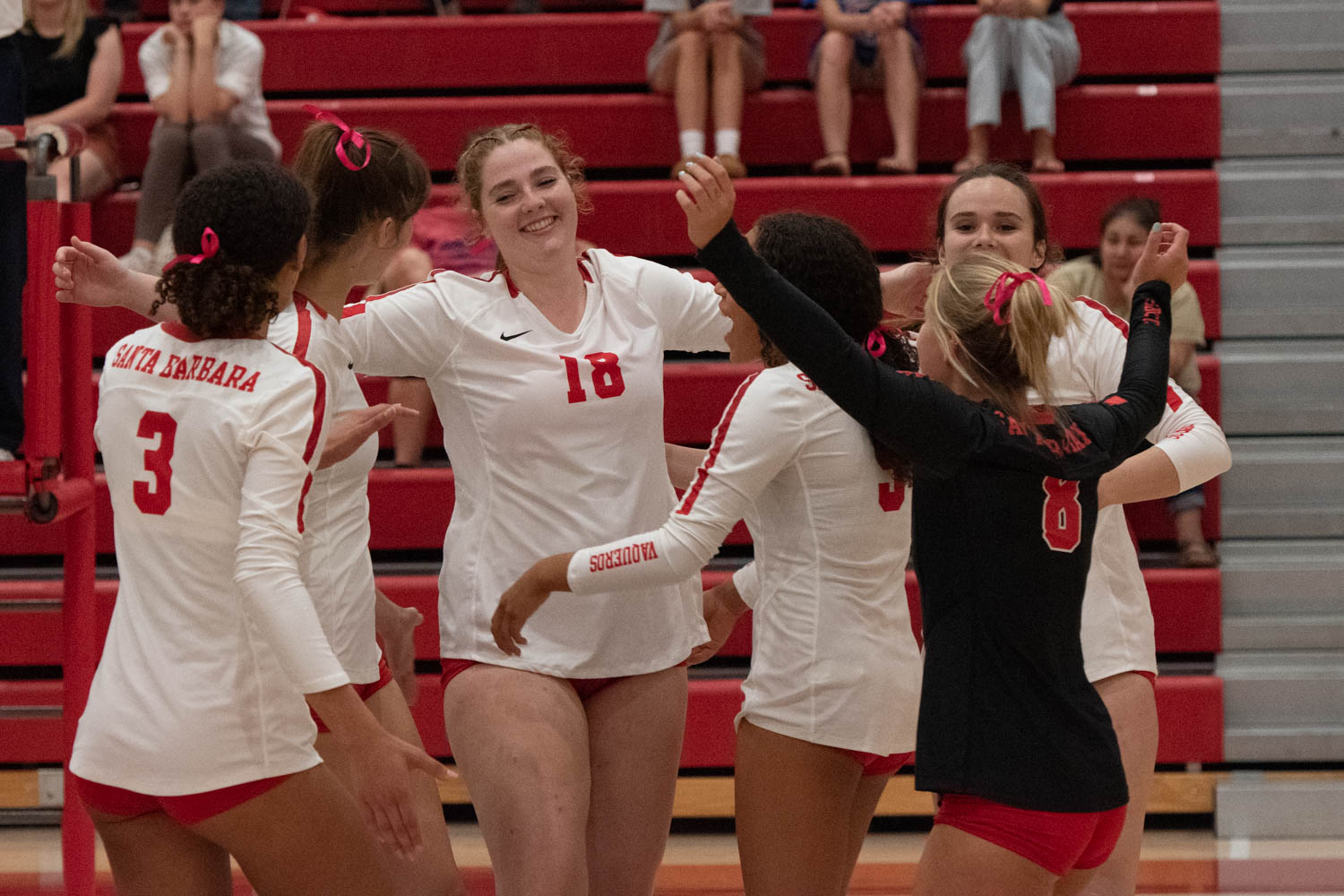 Teammates rush over to celebrate point scored by Brooke Alexander, no.18, against the LA Pierce Brahmas. The game was held at SBCC in Santa Barbara, Calif. on Oct 4.