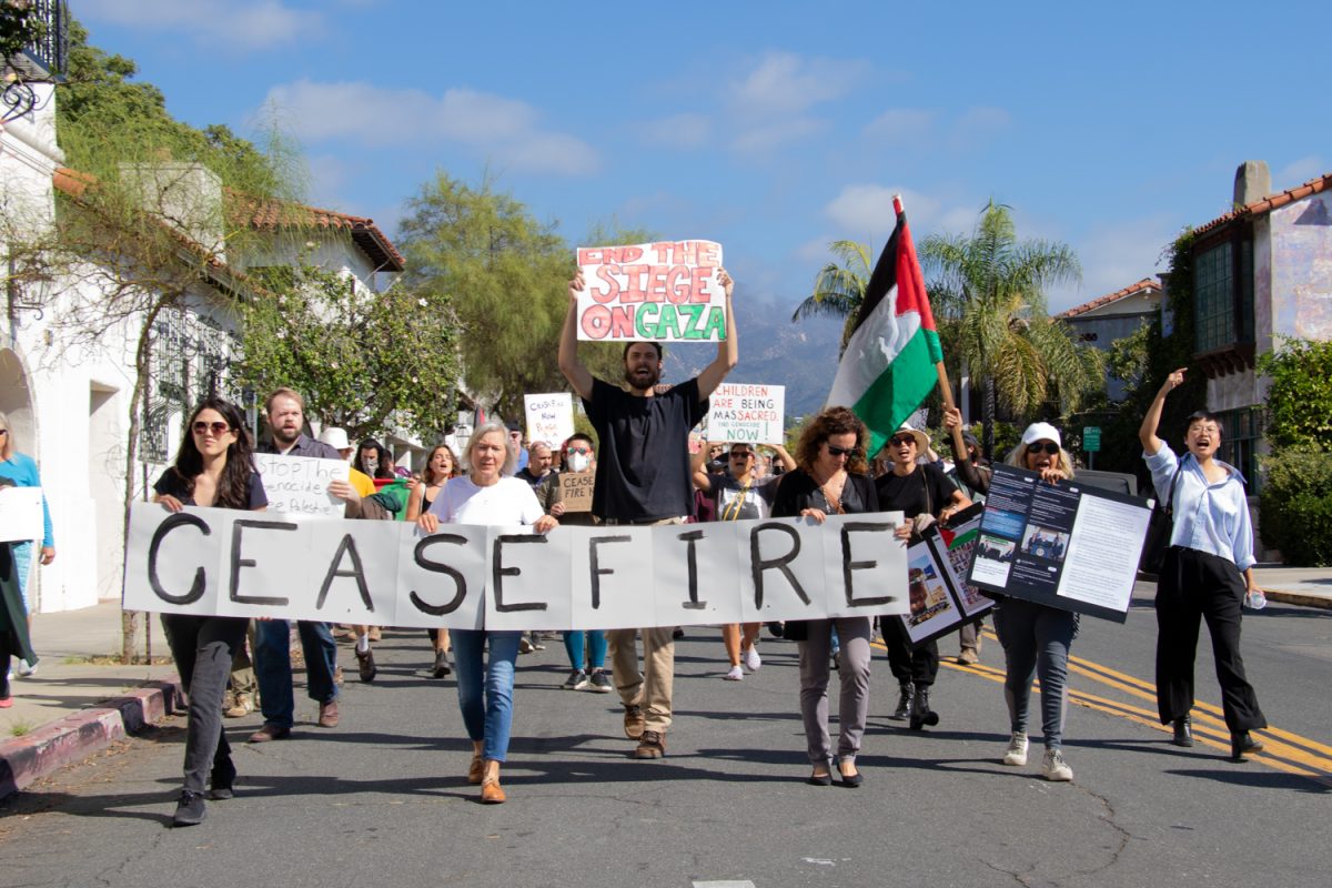 Members of Jewish Voice for Peace and other protesters march up State street, while chants and songs ring out on Oct. 24 in Santa Barbara, Calif. They carry signs reading "ceasefire," "end the siege on Gaza," and more.