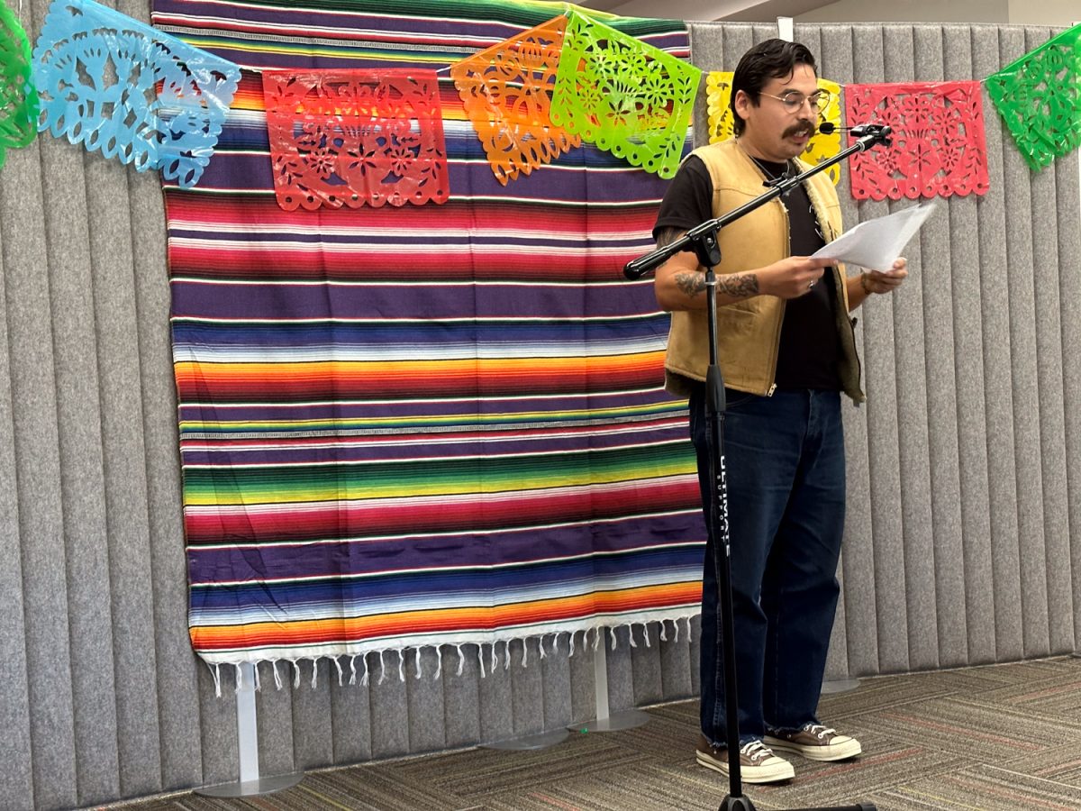 Edgar Alvarez pauses his librarian duties to share some original poetry before returning back to work on Oct. 5 in Santa Barbara, Calif. Alvarez is a new resident librarian at City Colleges Luria Library. 