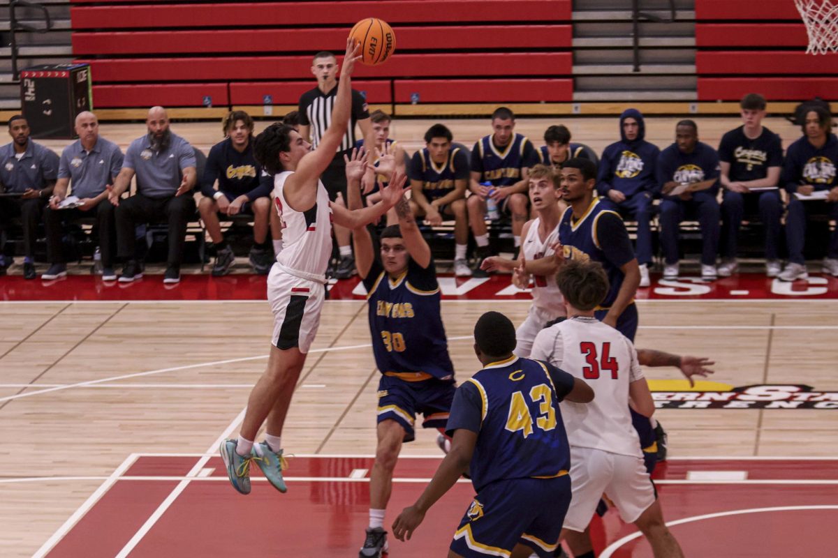 Guard Nick Tjaden floats the ball over a pool of defenders on Nov. 21 in the Sports Pavilion at City College in Santa Barbara, Calif. Tjaden tallied four points and four assists off the bench for the Vaqueros.