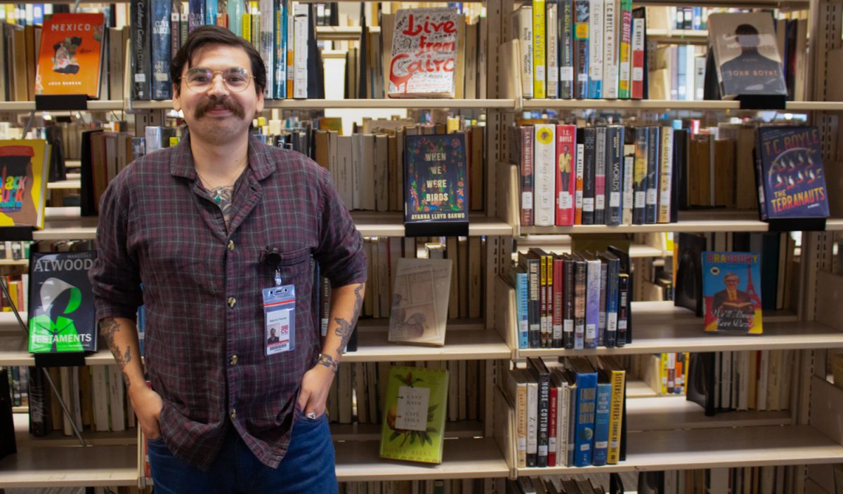 Edgar Alvarez standing in front of the nonfiction section on Wednesday, Nov. 1 inside the Luria Library at City College campus in Santa barbara, Calif. Nonfiction is Alvarez favorite genre of books.