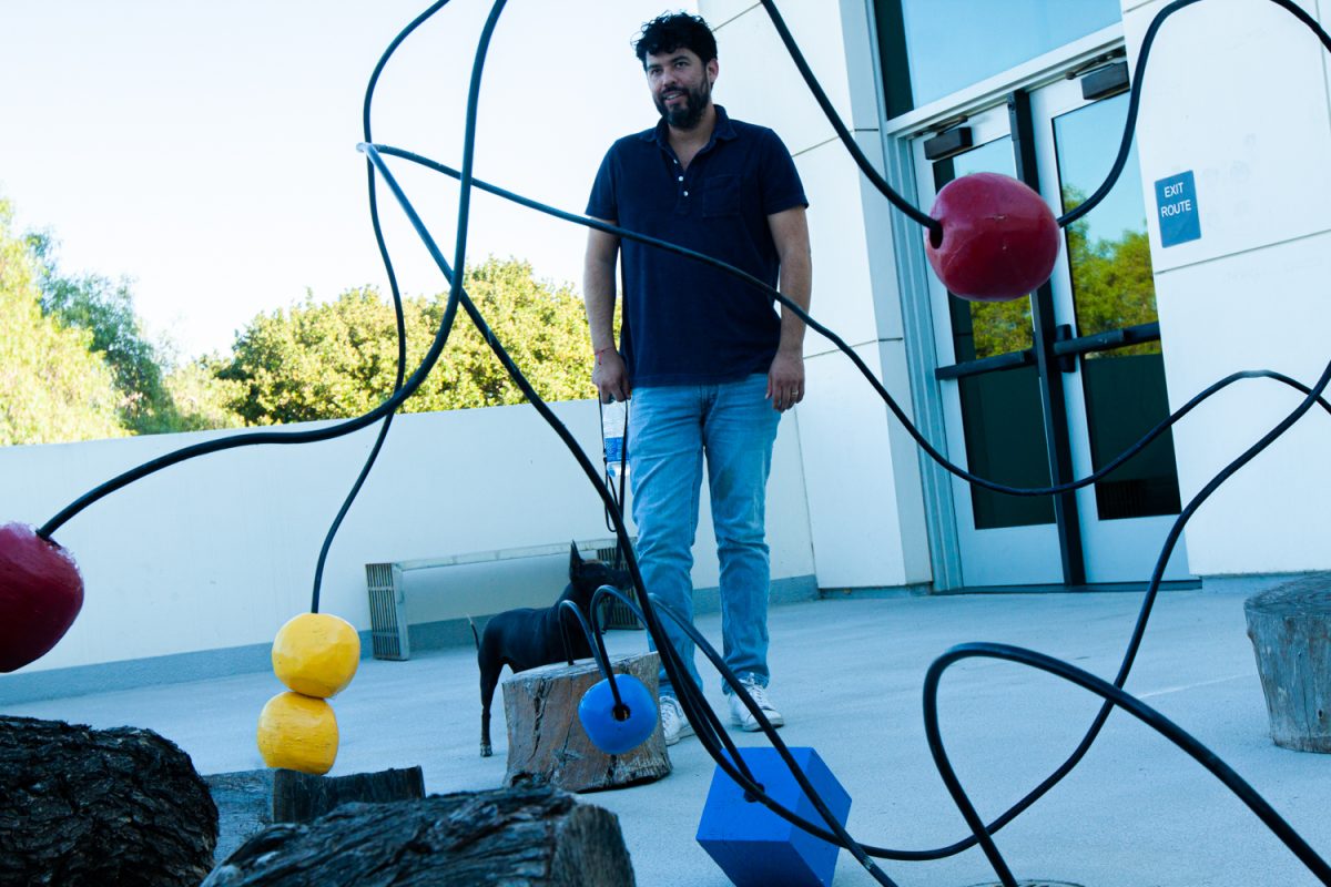 Freddy Janka, 41, observes an outdoor installation at the Atkinson Gallery on Nov. 1. Janka was attending the New Landscapes Part I exhibit opening at the gallery patio.