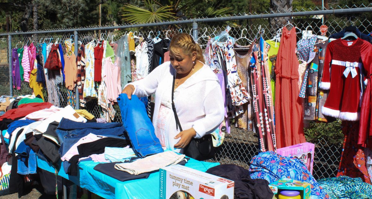 Rosario Romano selling jeans, dresses, and childrens toys at the flea market hosted at Santa Barbara High School on Saturday, Oct. 28 in Santa Barbara, Calif. She sets up her stand every weekend.