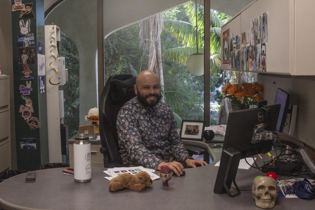 Ramon Borunda Jr., care director of EOPS, is at his desk in the Student Services building on the second floor, room 240, on Nov. 21. Borunda Jr. helps first generation, low income students get their feet and minds in the right direction with academic support and admissions assistance.