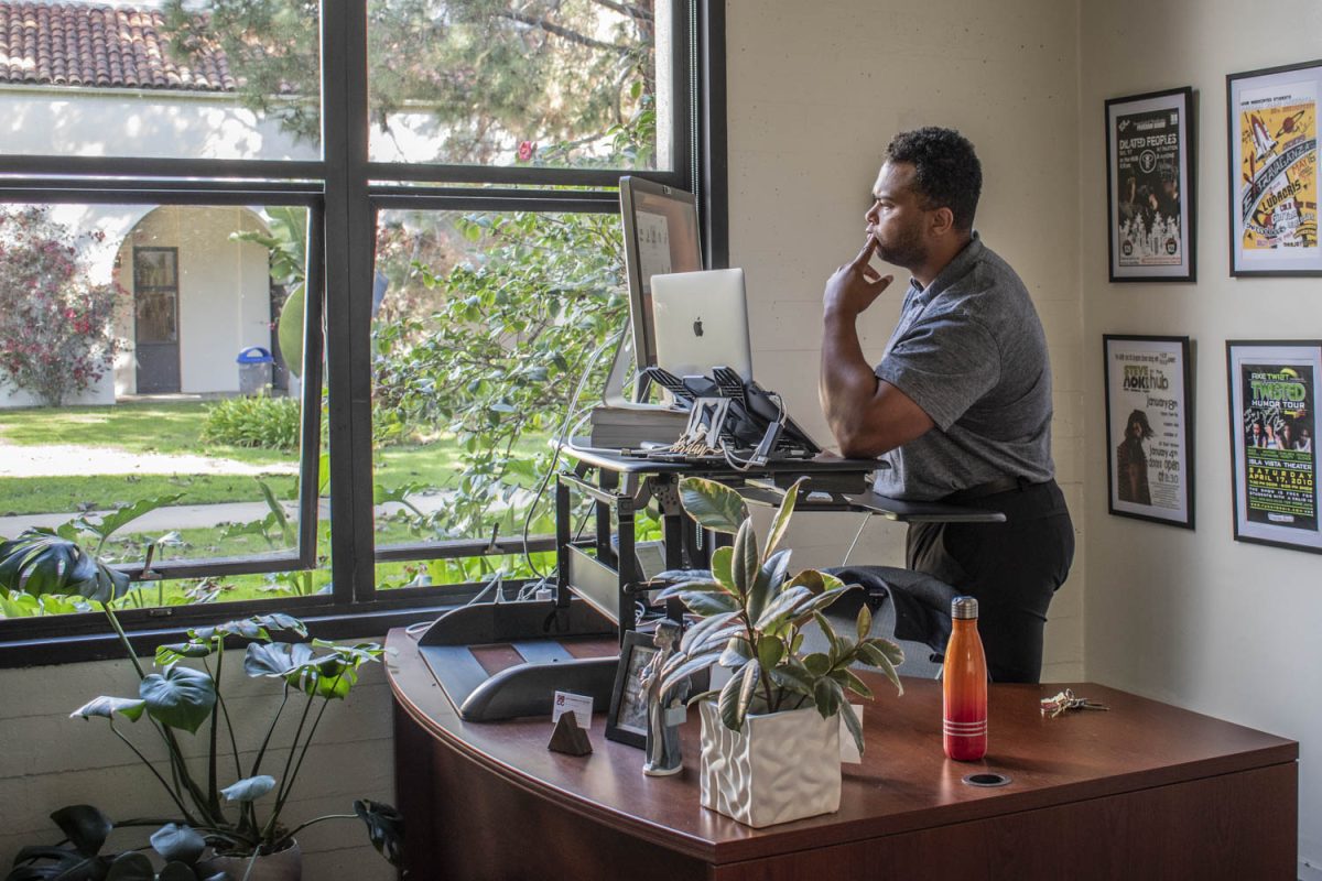 Jordan Killebrew works in the window light in his office on City College East Campus in Santa Barbara on Nov 29, 2023. Killebrew says I want to bring trust, I want to bring stability and I know we can get there.