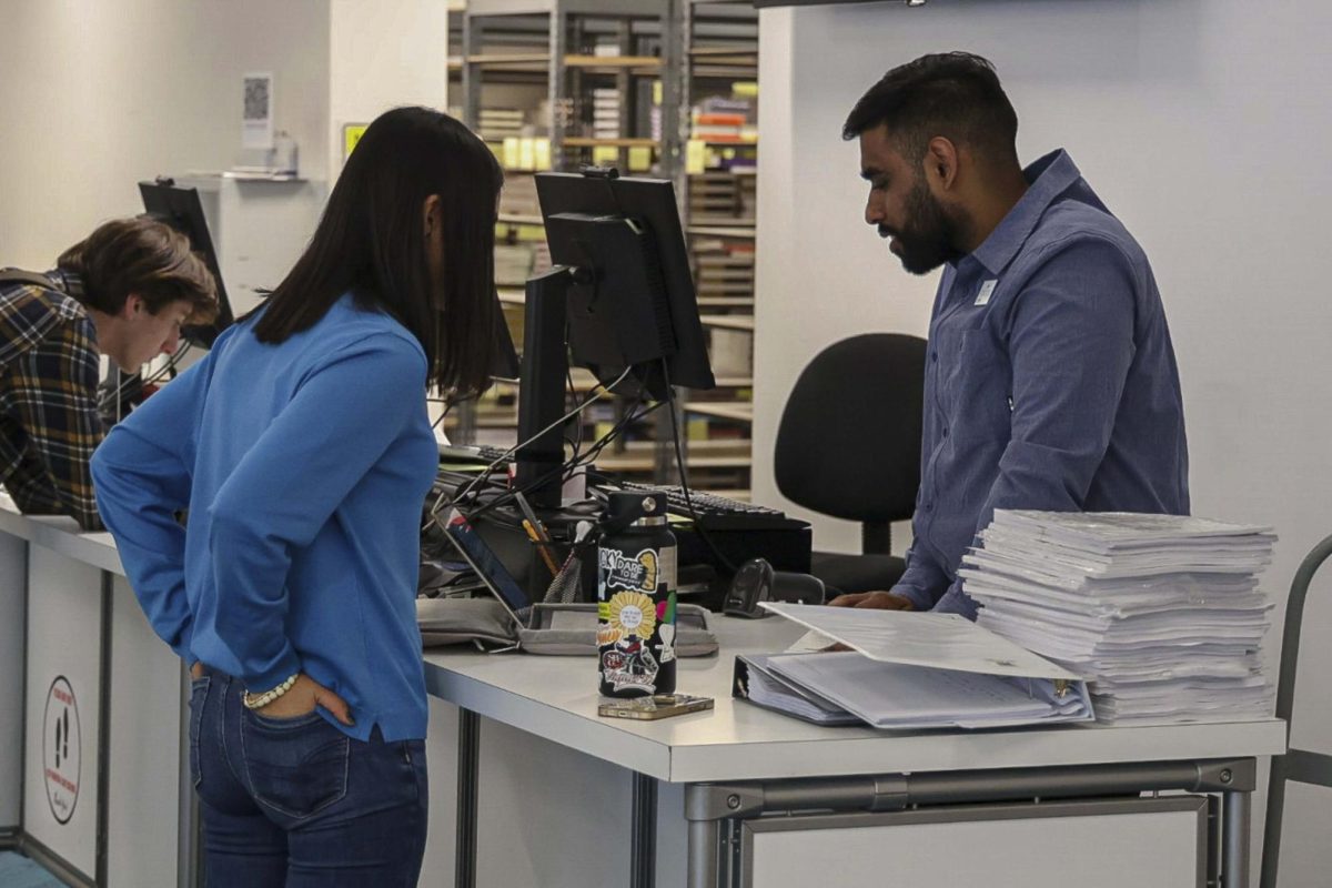 Honey Guzman gets assistance from a bookstore assistant on Jan. 29 at City College in Santa Barbara, Calif. Promise, EOPS, DSPS...we spend a lot of money on the books, and that helps me a lot, Guzman said.