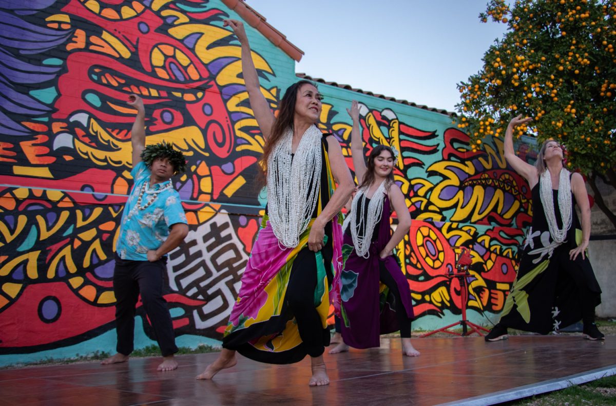 The Hula Anyone group dances in front of DJ Javier's mural curated for the Year of the Dragon festival on Feb. 10 in Santa Barbara, Calif. The mural was designed with Asian American and Pacific Islanders heritage in mind, thoughtfully stationed on one of the original Santa Barbara Chinatown buildings, now home to the Pickle Room. 