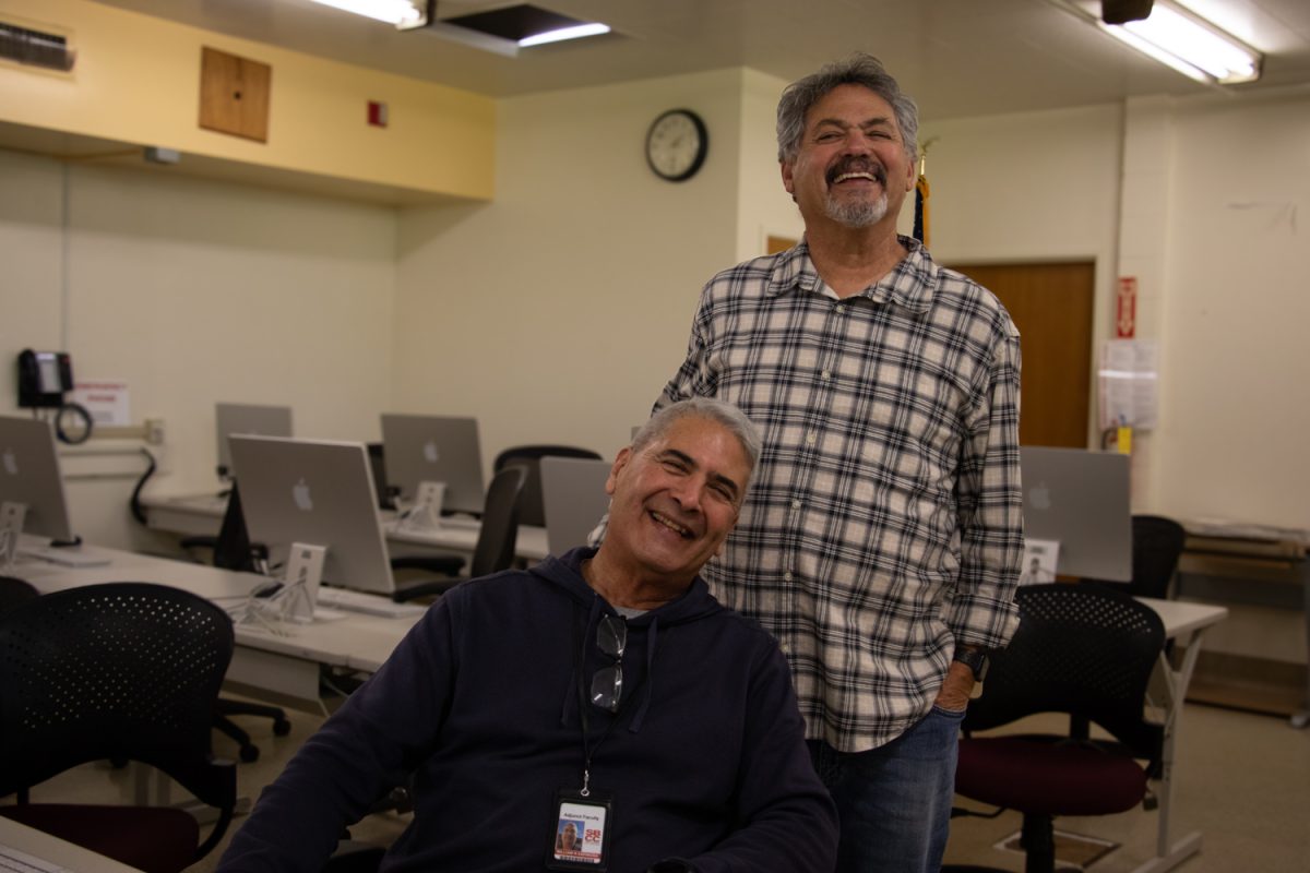 Bill (sitting) and Steve Espinosa show all smiles in the photography lab on Feb. 13 at City Colleges Wake Campus in Santa Barbara, Calif. The retired first responder and veteran host a digital photography class designated for retired veterans, first responders, and their spouses with photo equipment provided by Canon USA. 